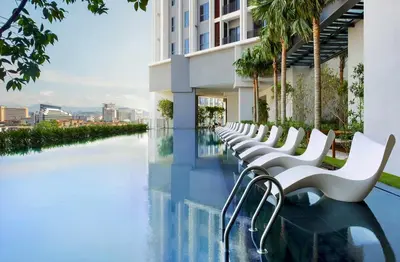 a row of white chairs on the side of a building at KLCC The Mews Home in Kuala Lumpur