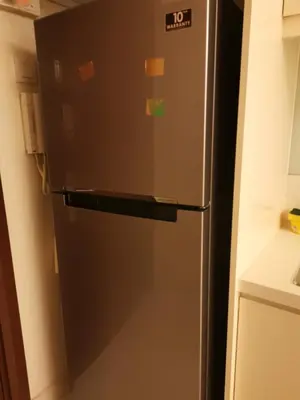 a refrigerator in a kitchen with many stickers on it at Corporate hotel suites at hartamas / mont kiara in Kuala Lumpur