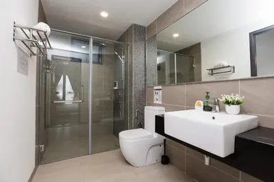 a bathroom with a toilet and a sink and a shower at Velocity KL By PSM Luxury Suites in Kuala Lumpur