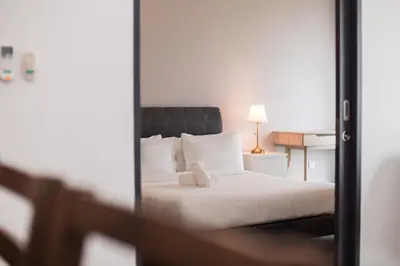 a bedroom with a bed and a mirror at Velocity KL By PSM Luxury Suites in Kuala Lumpur
