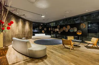 a living room with a couch and a table and chairs at E&O Residences Kuala Lumpur in Kuala Lumpur