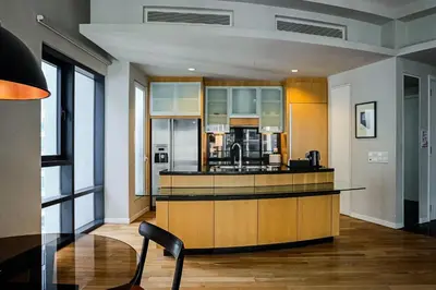 a large kitchen with a counter and a sink at E&O Residences Kuala Lumpur in Kuala Lumpur