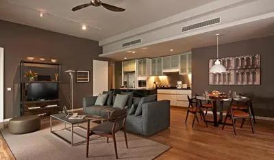 a living room with a couch and a table at E&O Residences Kuala Lumpur in Kuala Lumpur