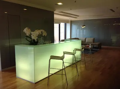 a kitchen with a bar with stools in a room at Times Service Suites @ Times Square in Kuala Lumpur