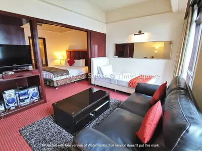 a living room with a couch and a bed at Times Service Suites @ Times Square in Kuala Lumpur