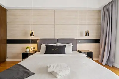a bedroom with a large bed with two night stands at Anggun Residences Serviced Suites in Kuala Lumpur