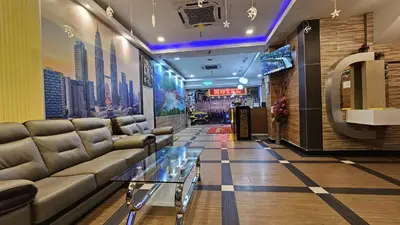 a lobby with a couch and a glass table at Safari Hotel in Kuala Lumpur
