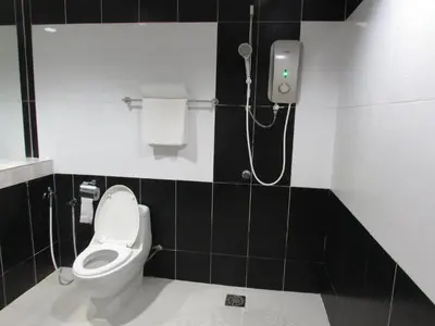 a bathroom with a toilet and a shower at Safari Hotel in Kuala Lumpur