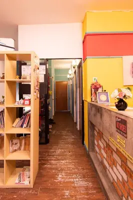 a hallway of a library with colorful walls at Travel Hub Guesthouse in Kuala Lumpur