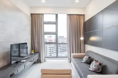 a living room with a couch and a large window at The Robertson Bukit Bintang in Kuala Lumpur