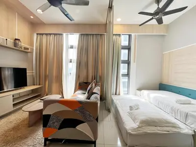 a living room with a couch and a tv at The Robertson Bukit Bintang in Kuala Lumpur