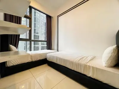 a bedroom with two beds and a large window at The Robertson Bukit Bintang in Kuala Lumpur