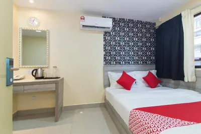 a bedroom with a bed and a desk and a mirror at Hotel O Kl Centre Point in Kuala Lumpur