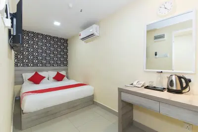 a bedroom with a bed and a desk with a mirror at Hotel O Kl Centre Point in Kuala Lumpur