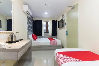 a hotel room with two beds and a bathroom at Hotel O Kl Centre Point in Kuala Lumpur