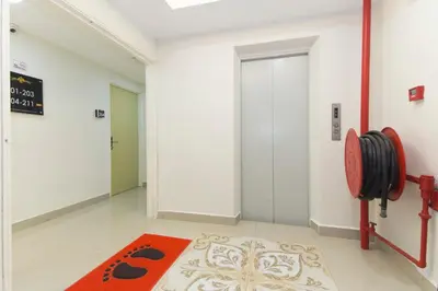 a hallway with a door and a red rug at Hotel O Kl Centre Point in Kuala Lumpur
