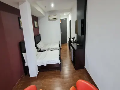 a small room with a bed and a kitchen at Hotel O Crossroads Hotel in Kuala Lumpur