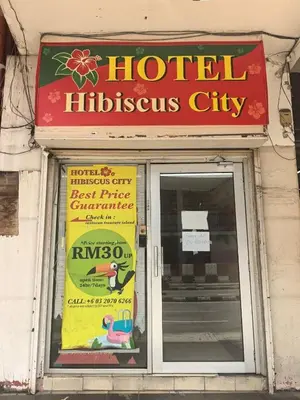 a store front with a sign in front of a door at Sha La La Hostel in Kuala Lumpur