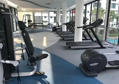 a gym with several treadmills and cardio machines at Velocity Residence in Kuala Lumpur