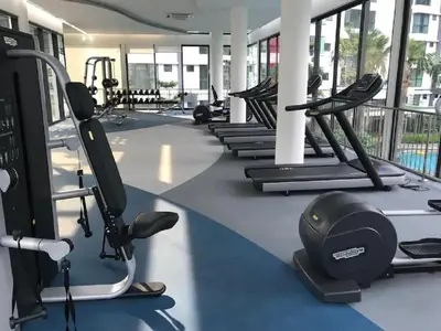 a gym with treadmills and elliptical machines at Velocity Residence in Kuala Lumpur