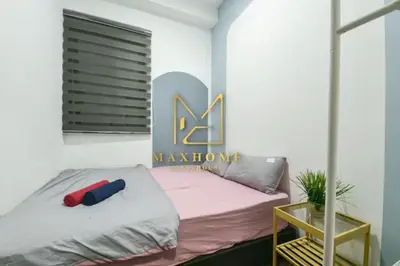 a bedroom with a bed with a sign on the wall at Velocity Residence in Kuala Lumpur