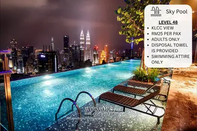 a swimming pool with a city skyline in the background at Expressionz Suites near KLCC, IJN by Wodages in Kuala Lumpur