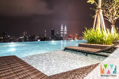 a swimming pool with a city skyline at night at Expressionz Suites near KLCC, IJN by Wodages in Kuala Lumpur