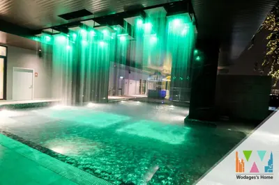 a swimming pool with green lights in a building at Expressionz Suites near KLCC, IJN by Wodages in Kuala Lumpur