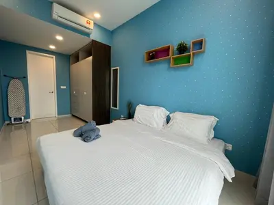 a bedroom with a large bed with a blue wall at The Robertson Bukit Bintang by Wowhome in Kuala Lumpur