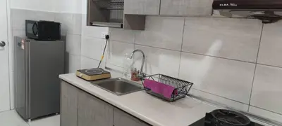 a kitchen counter with a sink and a refrigerator at The Robertson Bukit Bintang by Wowhome in Kuala Lumpur