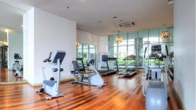 a gym with several treadmills and exercise machines at Regalia Upper View Hotel in Kuala Lumpur