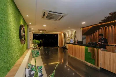 a hotel lobby with a green wall at My Hotel @ KL Sentral in Kuala Lumpur