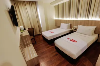 a hotel room with two beds and a television at My Hotel @ KL Sentral in Kuala Lumpur
