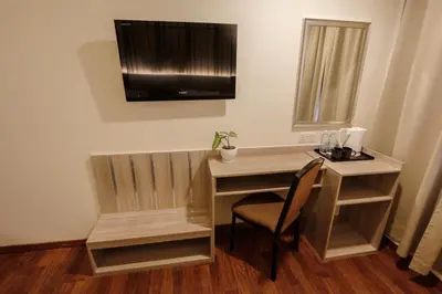 a desk in a room with a chair and a television at My Hotel @ KL Sentral in Kuala Lumpur