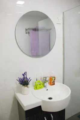 a bathroom with a white sink and a mirror at The FORUM condominium, Jalan Inai, Off Jalan Tun Razak in Kuala Lumpur