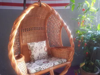 a wicker chair in a room with a plant at The FORUM condominium, Jalan Inai, Off Jalan Tun Razak in Kuala Lumpur