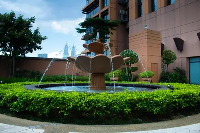 a fountain in the middle of a building at The Apartments at Times Square KL by Robinsons in Kuala Lumpur
