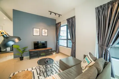 a living room with a couch and a tv at Arte Plus by Cobnb KLCC in Kuala Lumpur