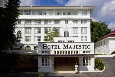 a woman stands in front of the hotel masisse at The Majestic Hotel Kuala Lumpur, Autograph Collection in Kuala Lumpur
