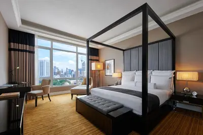 a hotel room with a bed and a large window at The Majestic Hotel Kuala Lumpur, Autograph Collection in Kuala Lumpur