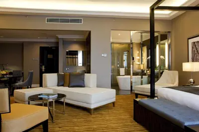 a living room with a white couch and a table at The Majestic Hotel Kuala Lumpur, Autograph Collection in Kuala Lumpur