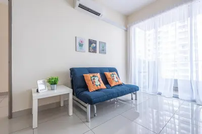 a blue chair in a room with a table and a window at PV21 Setapak, Share House Room Only in Kuala Lumpur