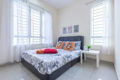 a bedroom with a bed with orange pillows on it at PV21 Setapak, Share House Room Only in Kuala Lumpur