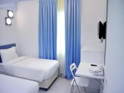 a bedroom with a bed and a table and a desk at YY318 Hotel Bukit Bintang in Kuala Lumpur