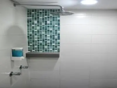 a bathroom with a window with a green tile wall at YY318 Hotel Bukit Bintang in Kuala Lumpur