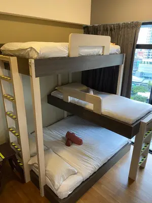 two bunk beds in a room with a window at Modern 3BR with Iconic KLCC Towers Skyline Views and Parking in Kuala Lumpur