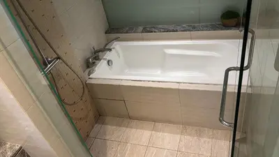 a white bath tub in a bathroom with at Modern 3BR with Iconic KLCC Towers Skyline Views and Parking in Kuala Lumpur