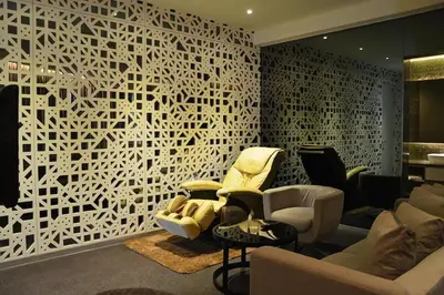 a living room with chairs and a white wall at Vivatel Kuala Lumpur in Kuala Lumpur