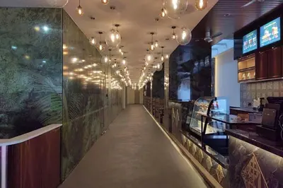 a long aisle in a restaurant with chandeliers at Vivatel Kuala Lumpur in Kuala Lumpur