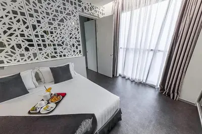a bedroom with a bed with a tray of food on it at Vivatel Kuala Lumpur in Kuala Lumpur